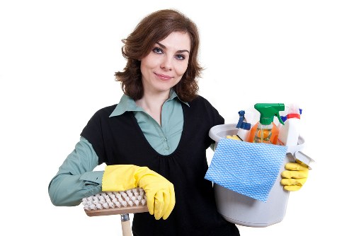 Cleaner in SW10 sanitising kitchen surfaces with care